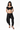 Conjunto total black de top bandeau con hombros descubiertos y pantalón holgado de tiro bajo.