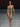 Look 24 desfile Un Romance Bien Latino 2026: vestido midi strapless entallado en estampado snake print arena y negro con abertura asimétrica lateral a la cadera, sandalias doradas de tacón con pulsera al tobillo.